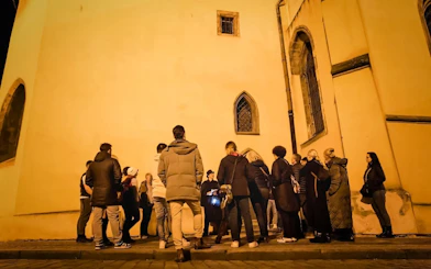 Tour group gathered at night in Old Town Prague for a Ghosts & Legends guided tour.