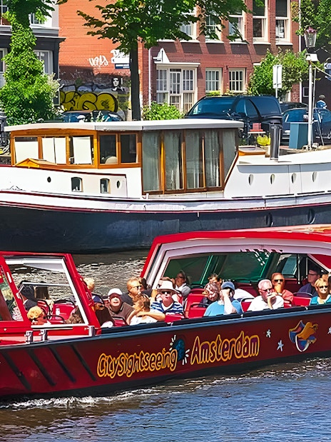 City Sightseeing Amsterdam boat on canal with tourists.
