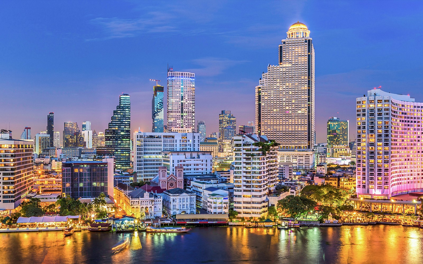 Chao Phraya River cruise with Bangkok skyline in the background
