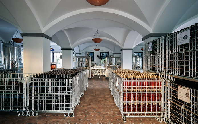 Wine cellar with bottles on Vesuvius slopes tour from Naples.