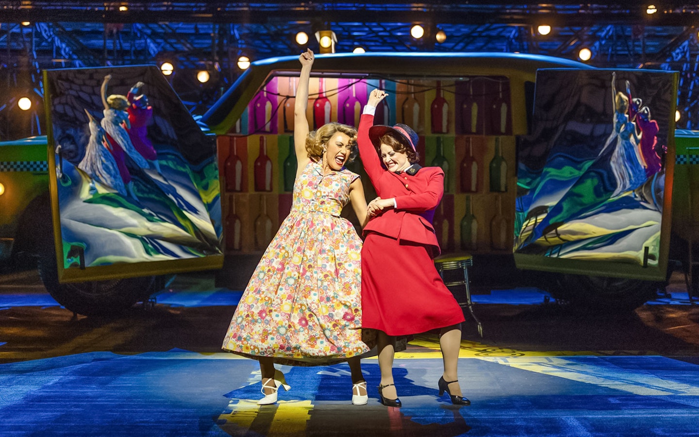 Performers dancing in vibrant costumes during "Guys & Dolls" on Sydney Harbour stage.