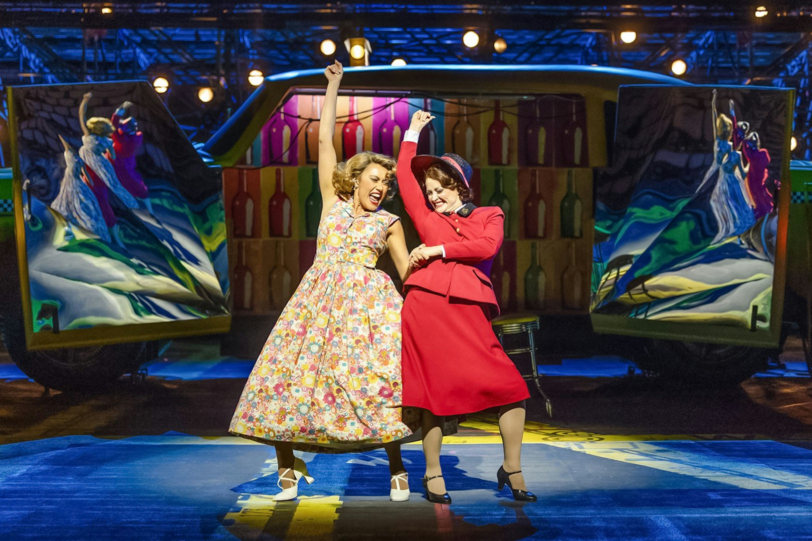 Performers dancing in vibrant costumes during "Guys & Dolls" on Sydney Harbour stage.