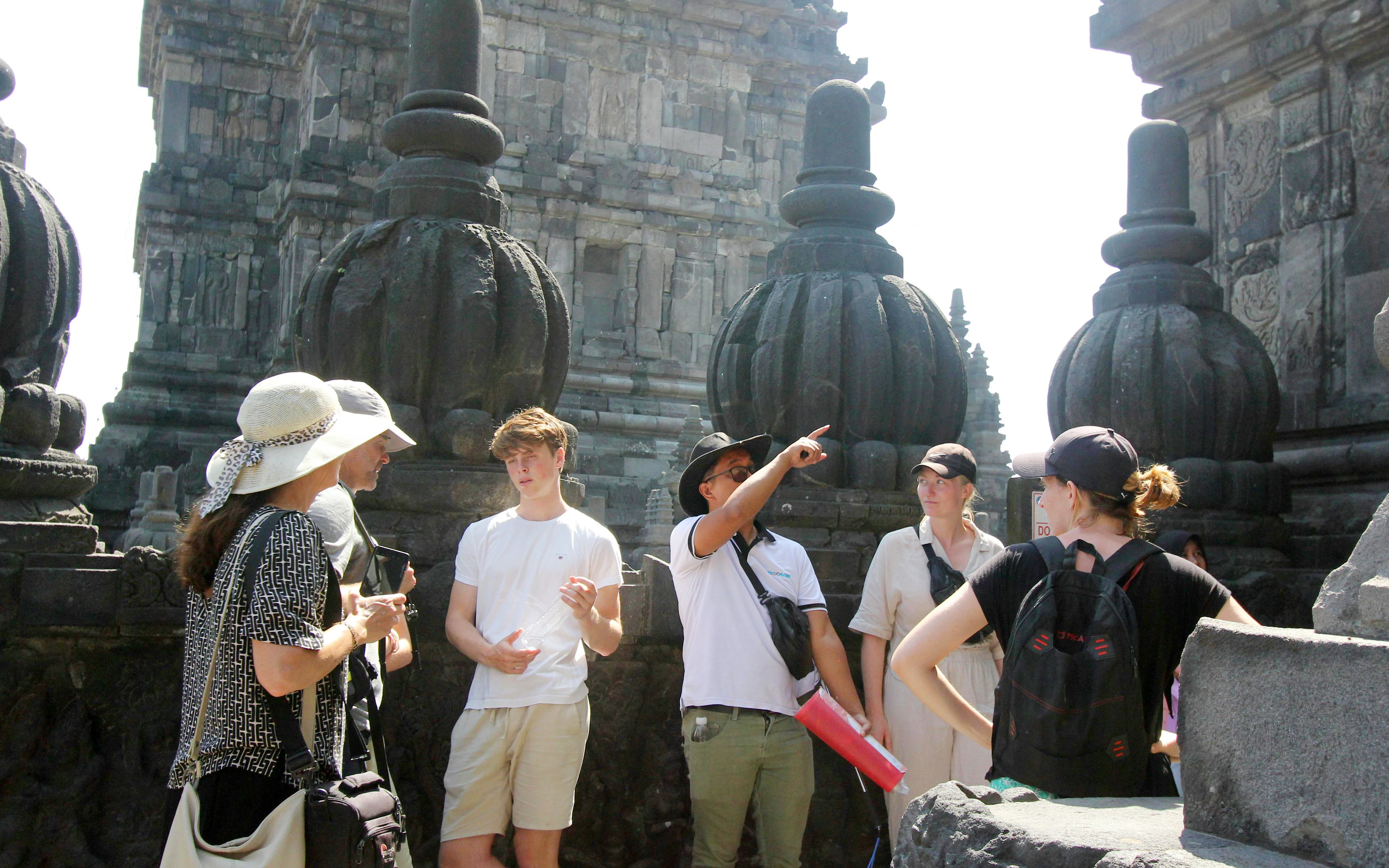 Tour group with guide at Borobudur Temple, Indonesia.