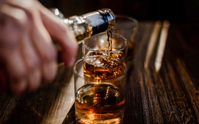 Whiskey being poured into glasses at the Irish Whiskey Museum tour.