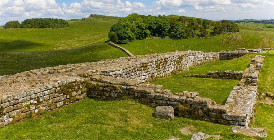 Housesteads Roman Fort ruins on Hadrian's Wall, Northumberland, England, showcasing ancient stone structures.