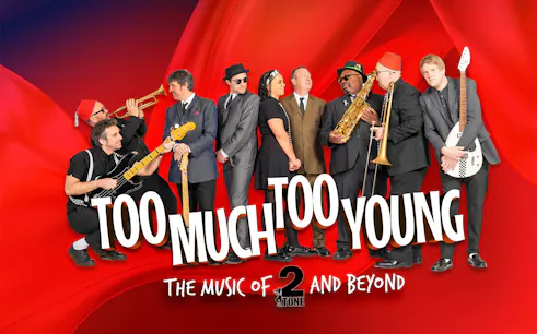 Band performing "Too Much Too Young" with instruments on a red background.