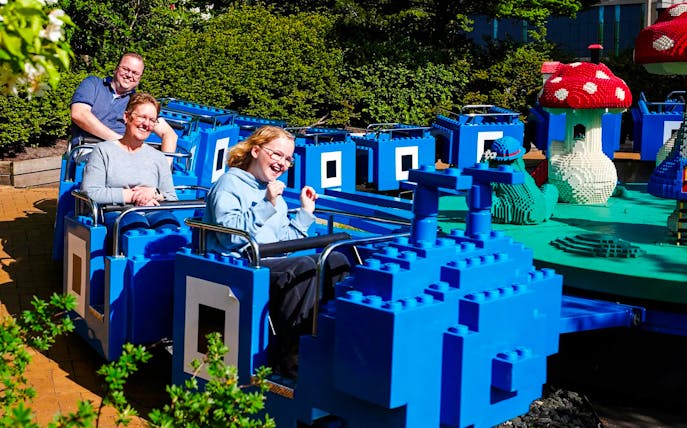 Guests on a LEGO-themed ride at LEGOLAND Billund.