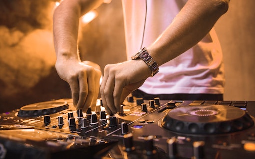 DJ mixing music on a cruise during New Year's Eve dinner event.