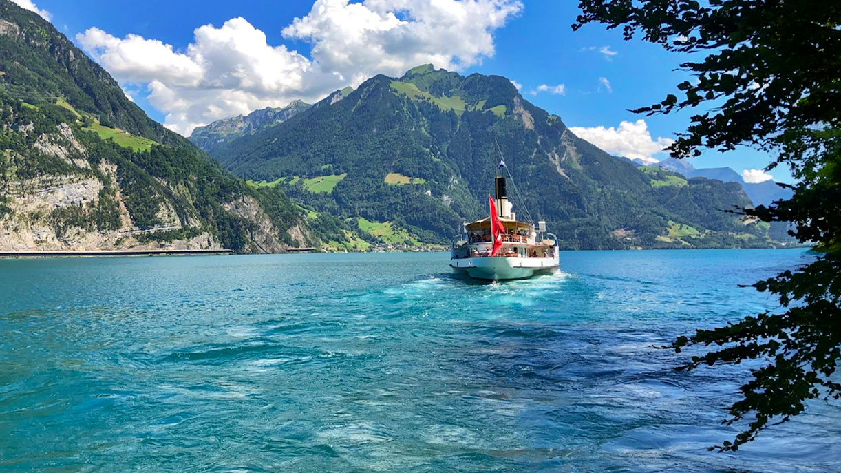 Boat cruising on Lake Lucerne with Mount Pilatus in the background.