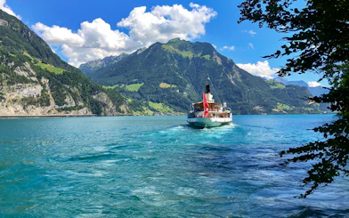 Boat cruising on Lake Lucerne with Mount Pilatus in the background.