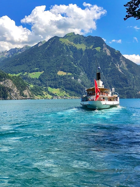 Boat cruising on Lake Lucerne with Mount Pilatus in the background.
