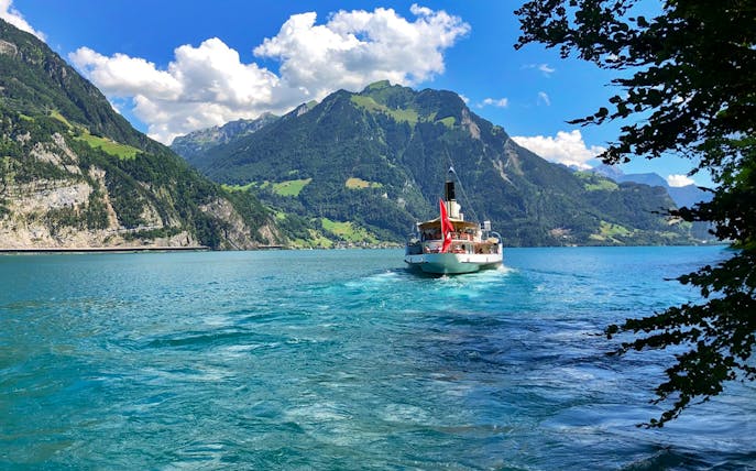 Boat cruising on Lake Lucerne with Mount Pilatus in the background.