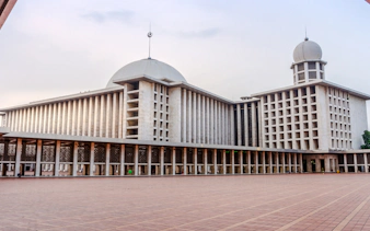 Istiqlal Mosque exterior in Jakarta, featured on a multilingual guided tour.