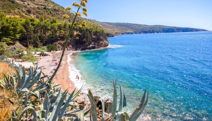 Kamenice Beach with clear blue waters and rocky shoreline in Vis, Croatia.