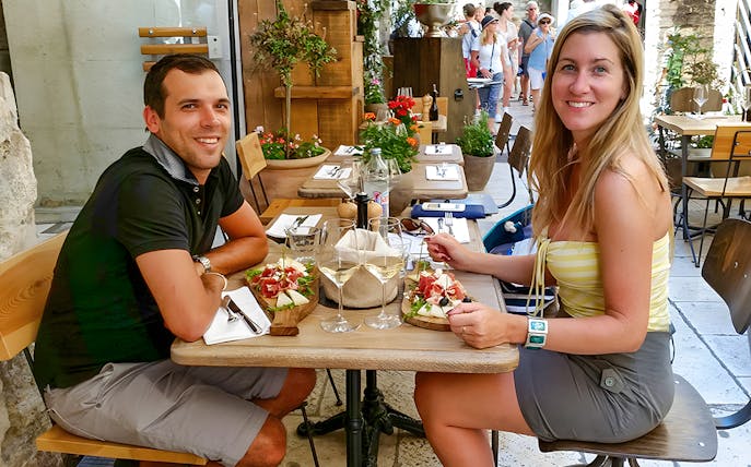 Wine tasting at an outdoor café in Diocletian's Palace, Split, with charcuterie.