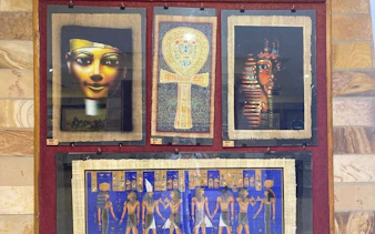 Ancient Egyptian papyrus art display in Hurghada shop.