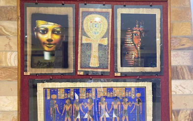 Ancient Egyptian papyrus art display in Hurghada shop.