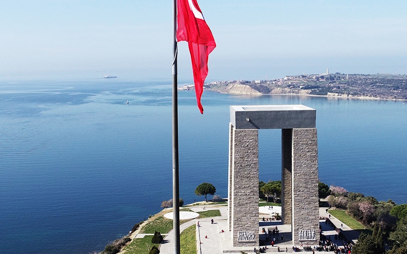 Gallipoli Martyrs' Memorial with Turkish flag overlooking the sea.