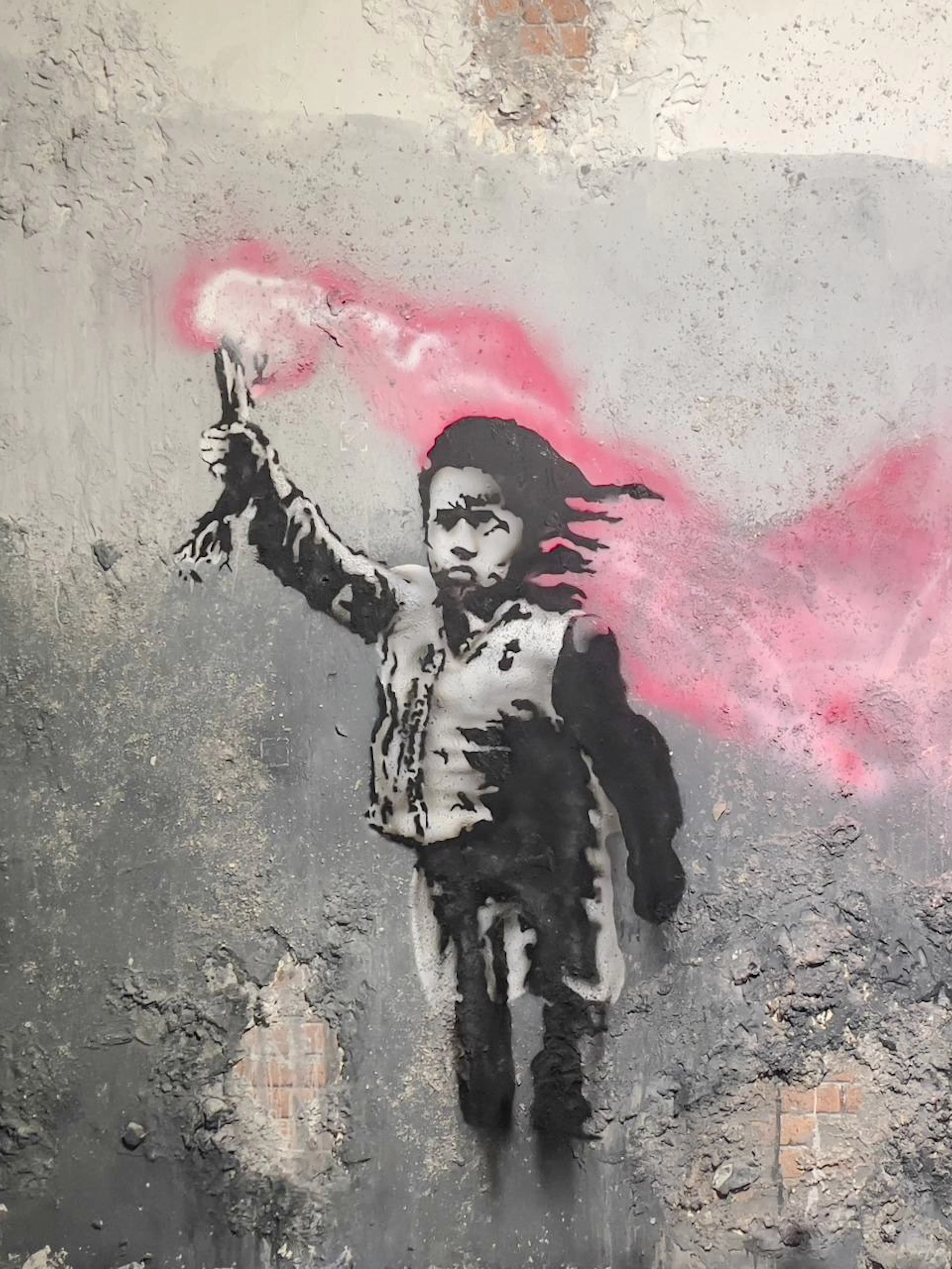 Street art of a child with a pink flare at Banksy Museum, Amsterdam.