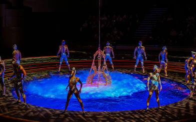 Acrobats performing around a water stage at La Perle show in Dubai.