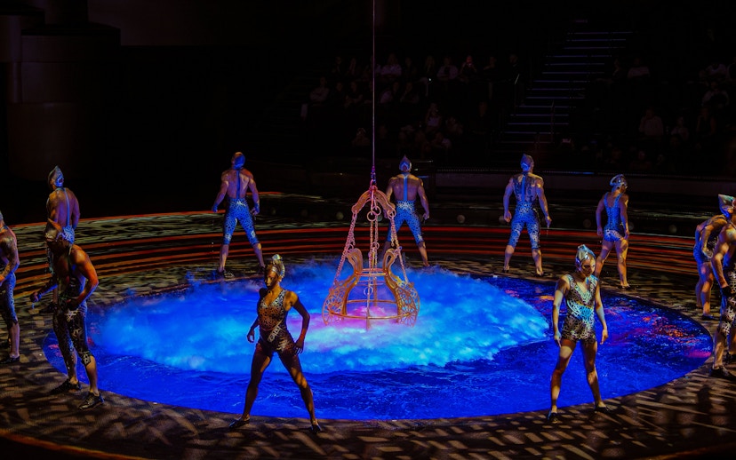 Acrobats performing around a water stage at La Perle show in Dubai.