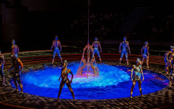 Acrobats performing around a water stage at La Perle show in Dubai.