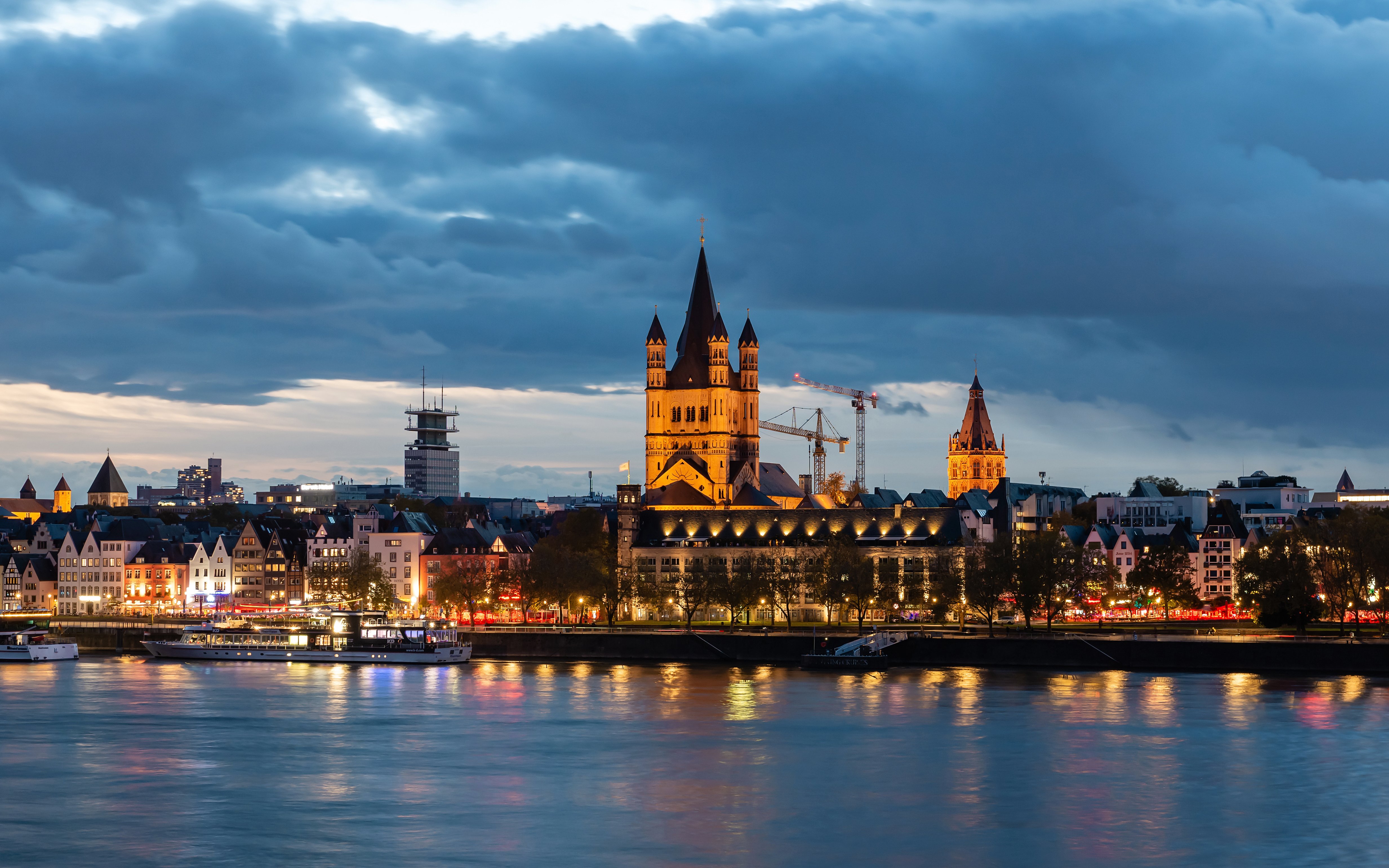 Cologne Old Town skyline with Great St. Martin Church at sunset.