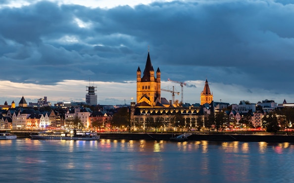 Cologne Old Town skyline with Great St. Martin Church at sunset.