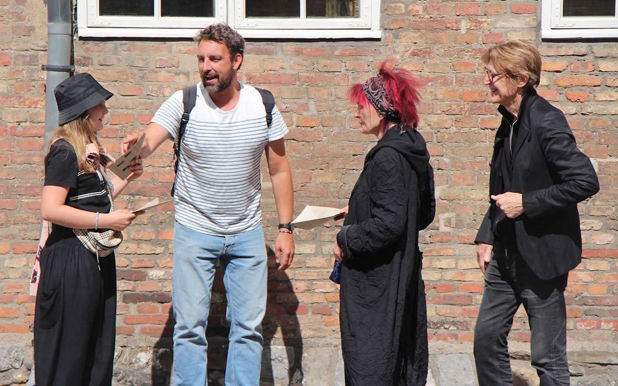 Group discussing clues for Murder Mystery Experience at Round Tower, Copenhagen.