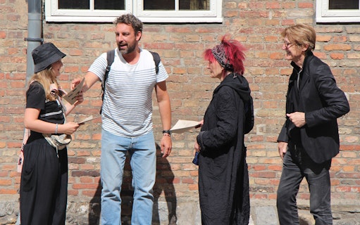 Group discussing clues for Murder Mystery Experience at Round Tower, Copenhagen.