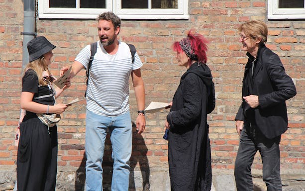 Group discussing clues for Murder Mystery Experience at Round Tower, Copenhagen.