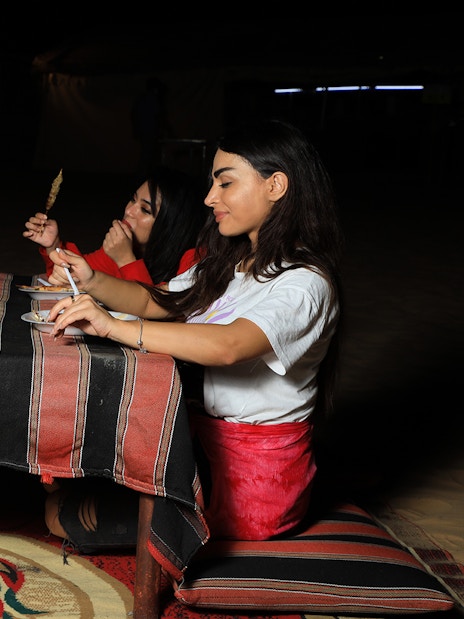 Dining at a Bedouin camp during Arabian Dunes Premium Safari.