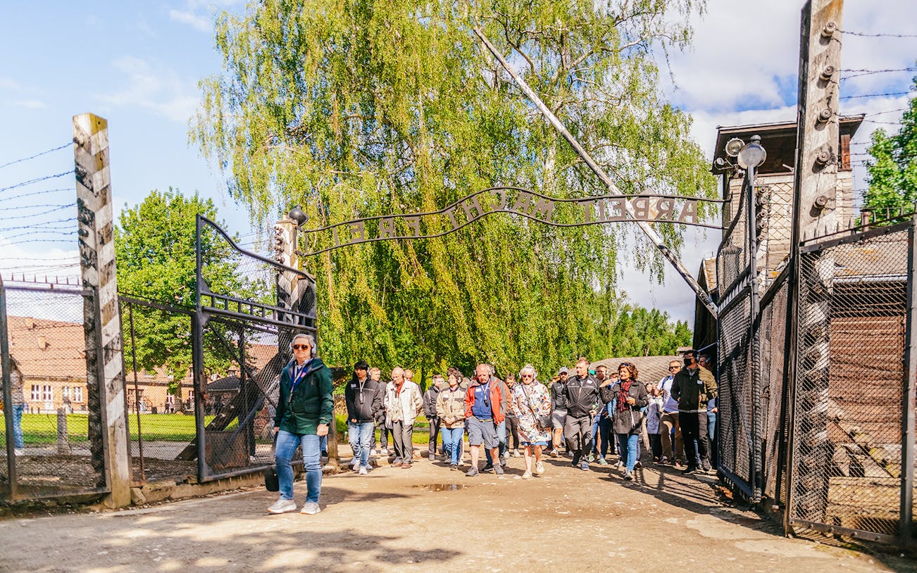 Guests entering Auschwitz-Birkenau gate on guided tour from Krakow.