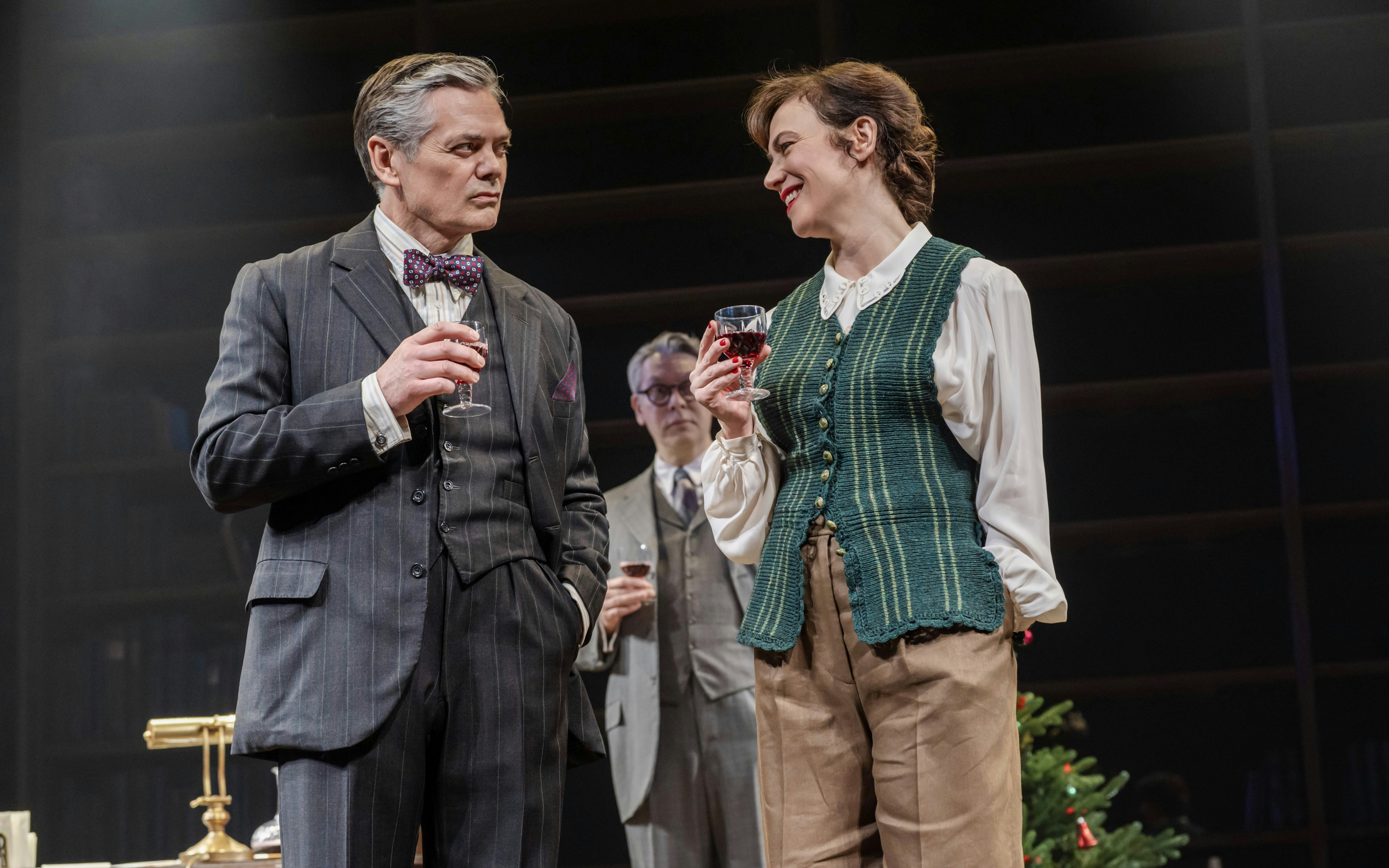 Stage actors in Shadowlands, Westend, holding wine glasses during a performance.