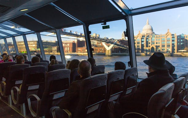 Passengers view Millennium Bridge from Uber Boat by Thames Clippers.