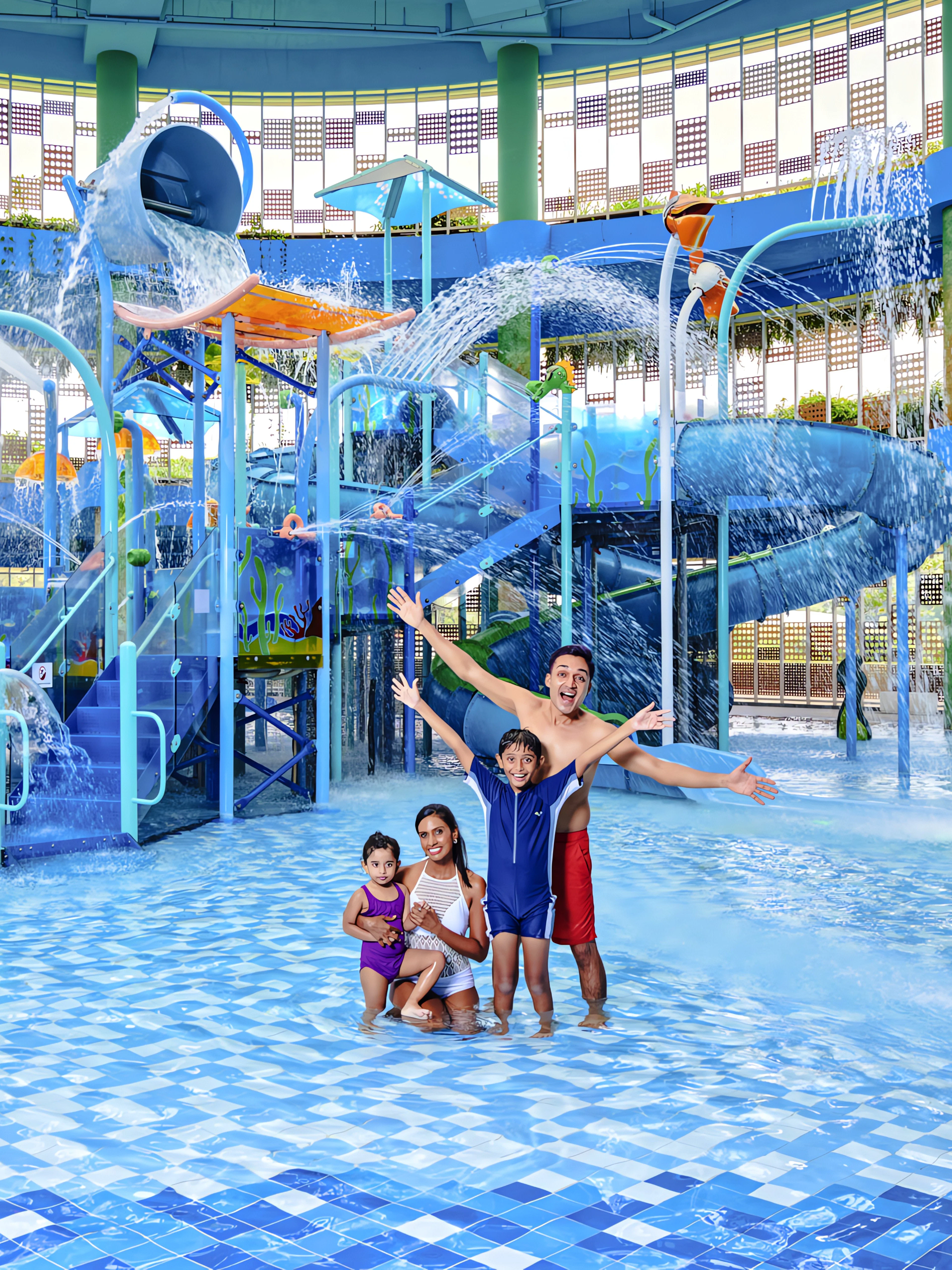 Family enjoying water park with slides and fountains in Singapore.