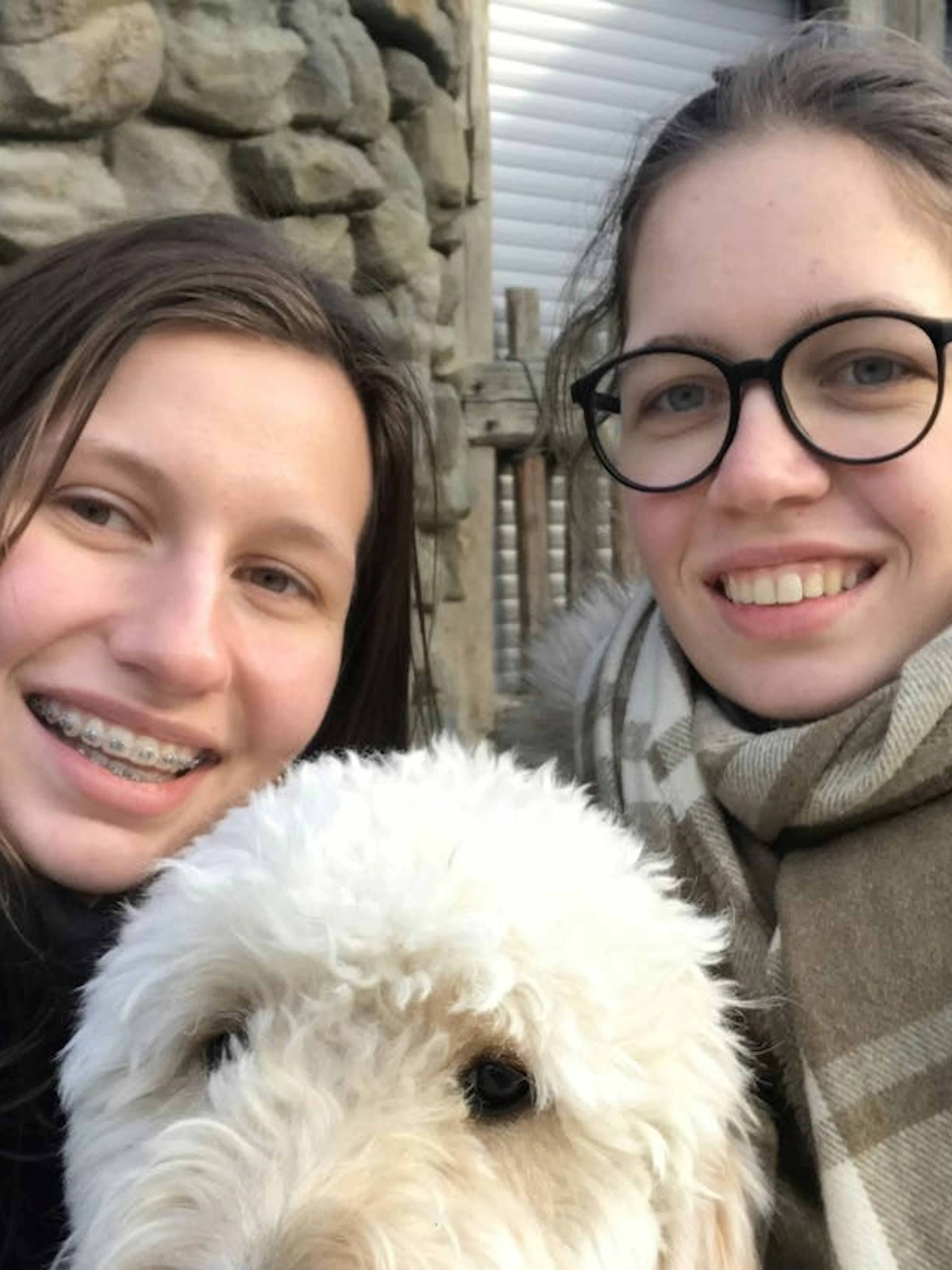Two people smiling with a dog at Vienna Prater during a self-guided city exploration game.