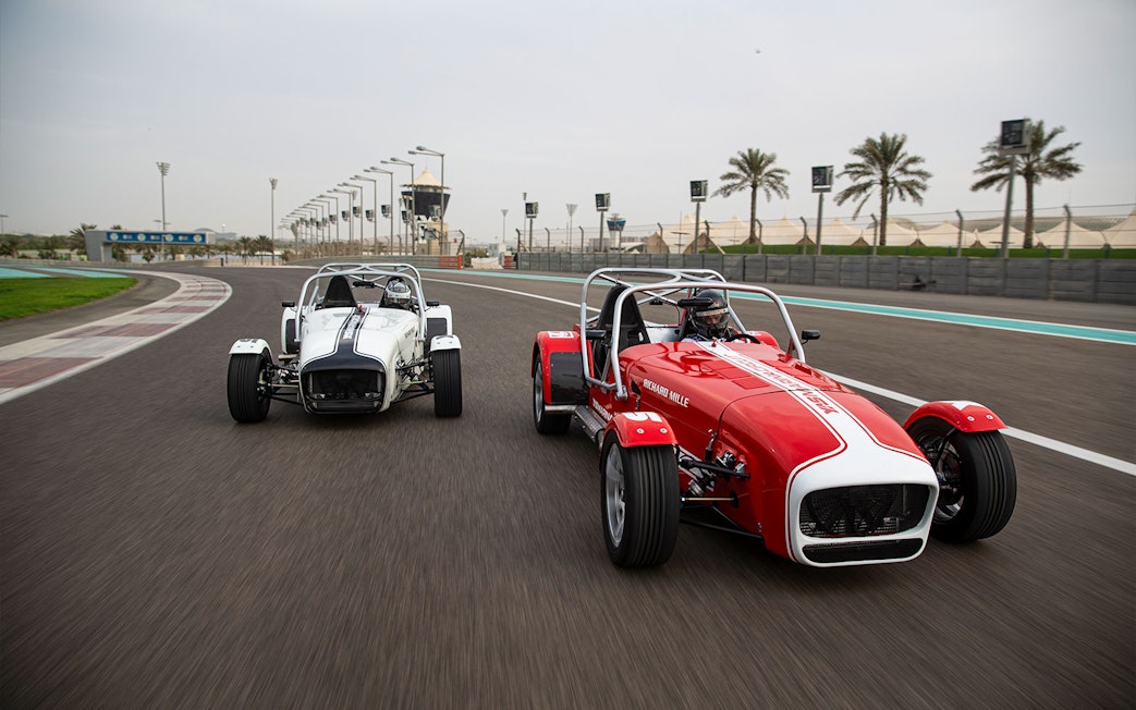 Caterham Seven 360 cars racing on Yas Marina Circuit track.