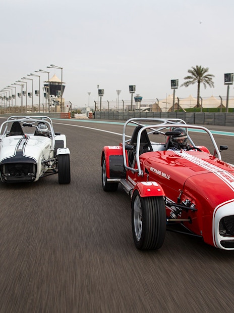 Caterham Seven 360 cars racing on Yas Marina Circuit track.