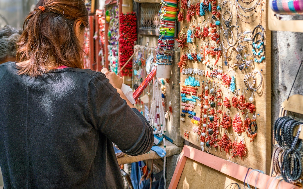Artisan jewelry stall in Amalfi, featuring colorful necklaces and bracelets.