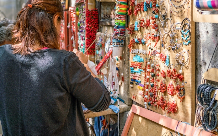 Artisan jewelry stall in Amalfi, featuring colorful necklaces and bracelets.
