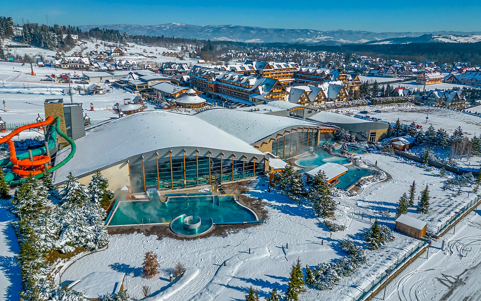 Aerial view of Terma Bania's snow-covered exterior and pools in Krakow.