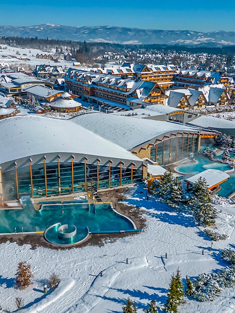 Aerial view of Terma Bania's snow-covered exterior and pools in Krakow.
