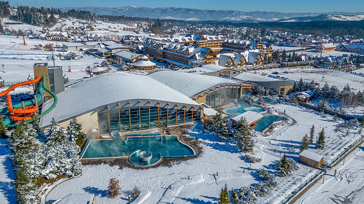 Aerial view of Terma Bania's snow-covered exterior and pools in Krakow.