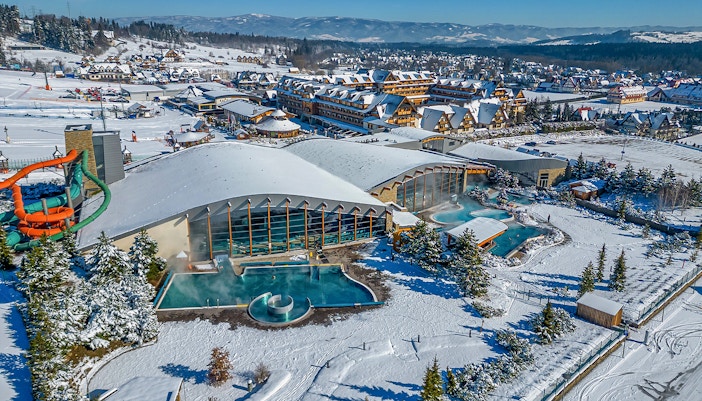 Aerial view of Terma Bania's snow-covered exterior and pools in Krakow.