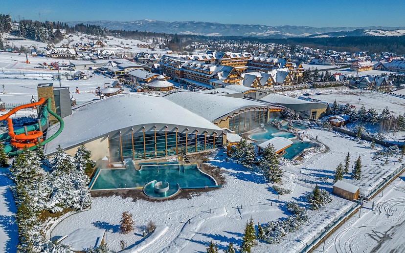 Aerial view of Terma Bania's snow-covered exterior and pools in Krakow.