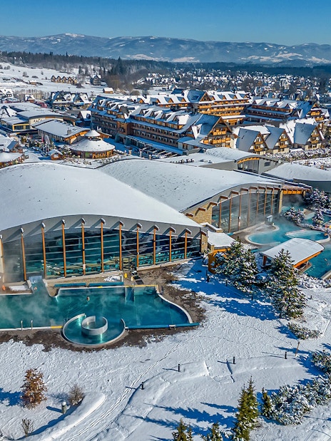 Aerial view of Terma Bania's snow-covered exterior and pools in Krakow.