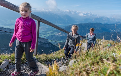 Family hiking on Mount Pilatus trail with scenic views, Lucerne.