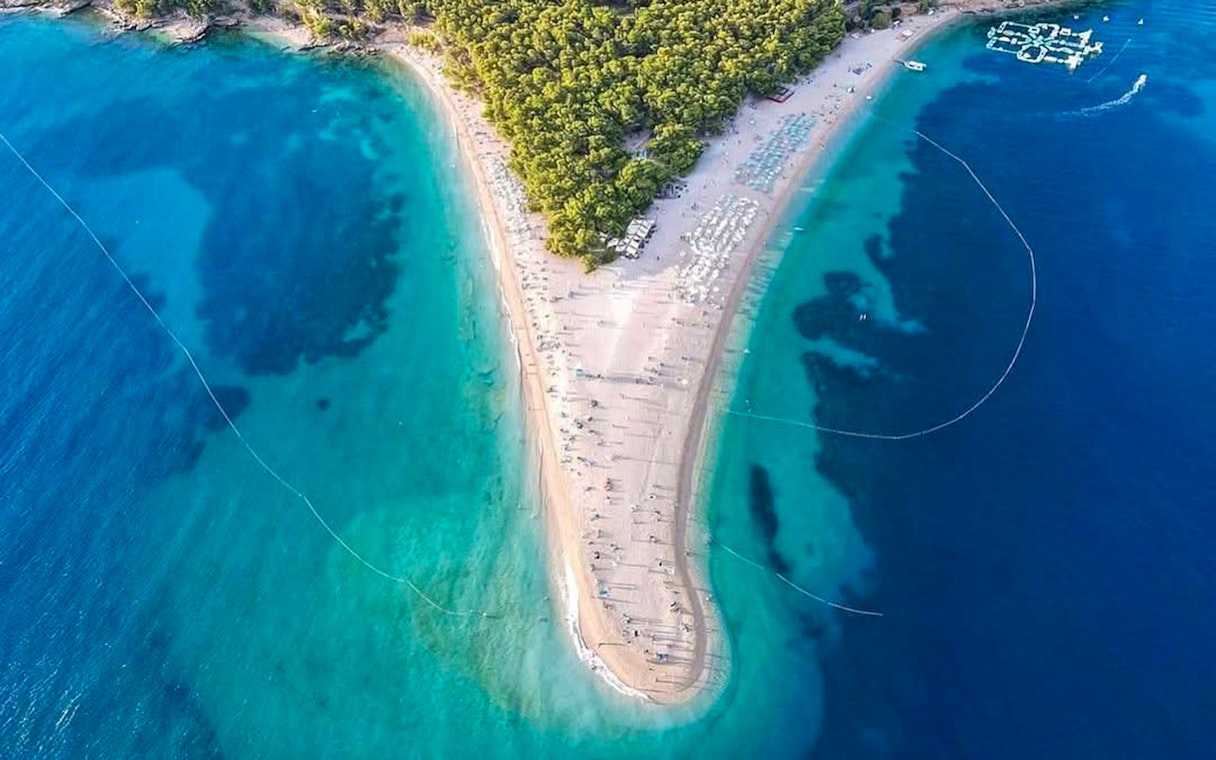 Aerial view of Zlatni Rat beach, Croatia, with turquoise waters and sandy shoreline.