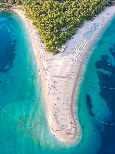 Aerial view of Zlatni Rat beach, Croatia, with turquoise waters and sandy shoreline.